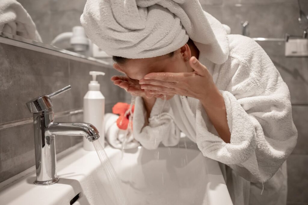Woman washing her face for the best face wash for oily skin guide