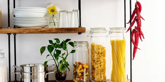 Glass jars of pasta on a kitchen shelf